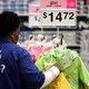 A so-called "worker" engages in an activity best described as "displaying" children's "raincoats."